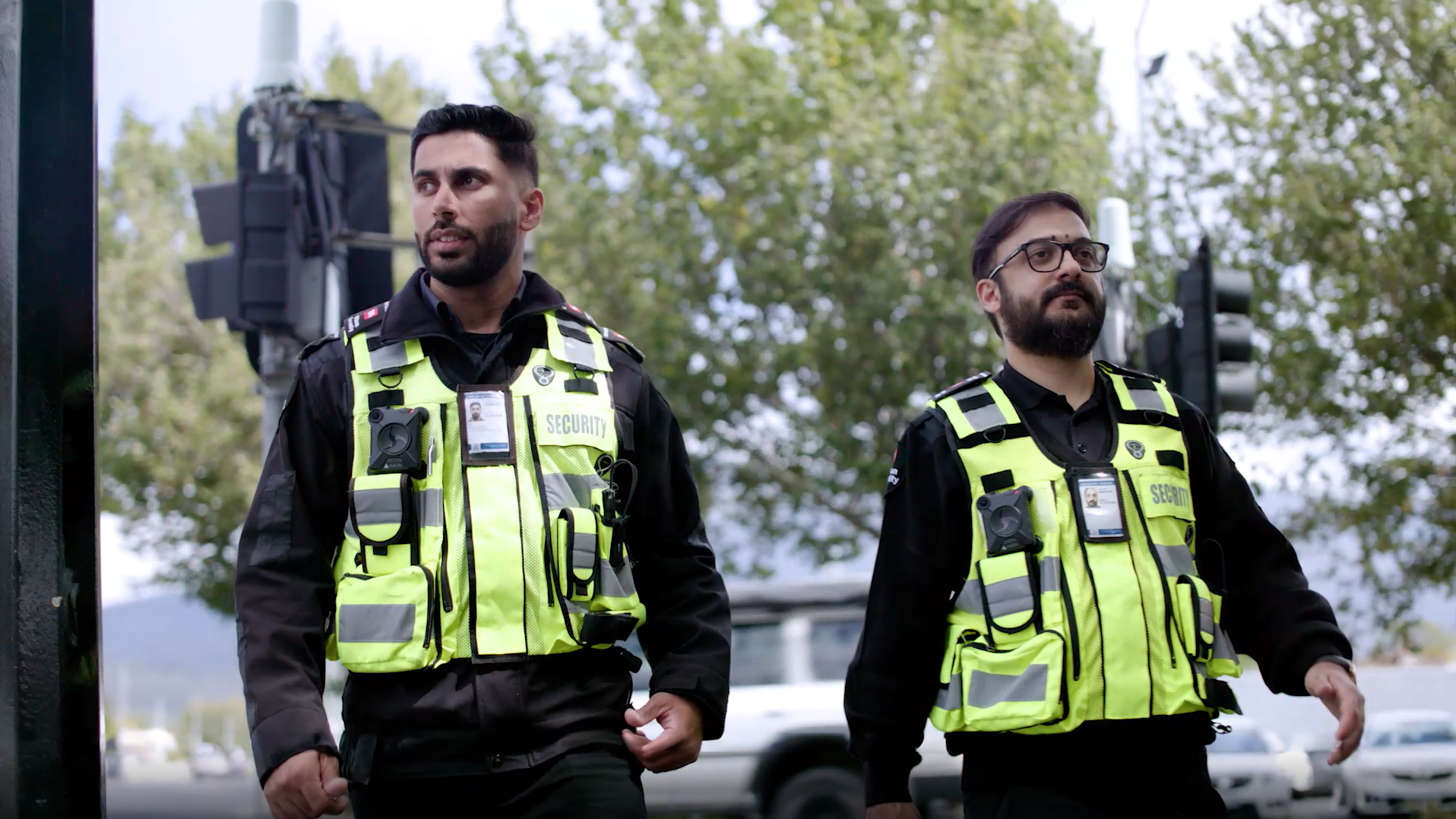 Two security guards with body worn cameras patrolling