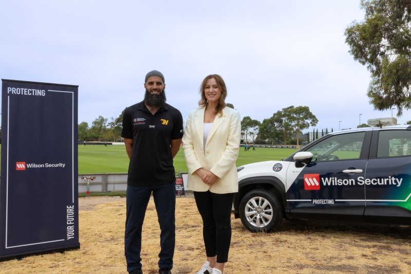 Bachar Houli and Betti posing in front of Wilson Security sign